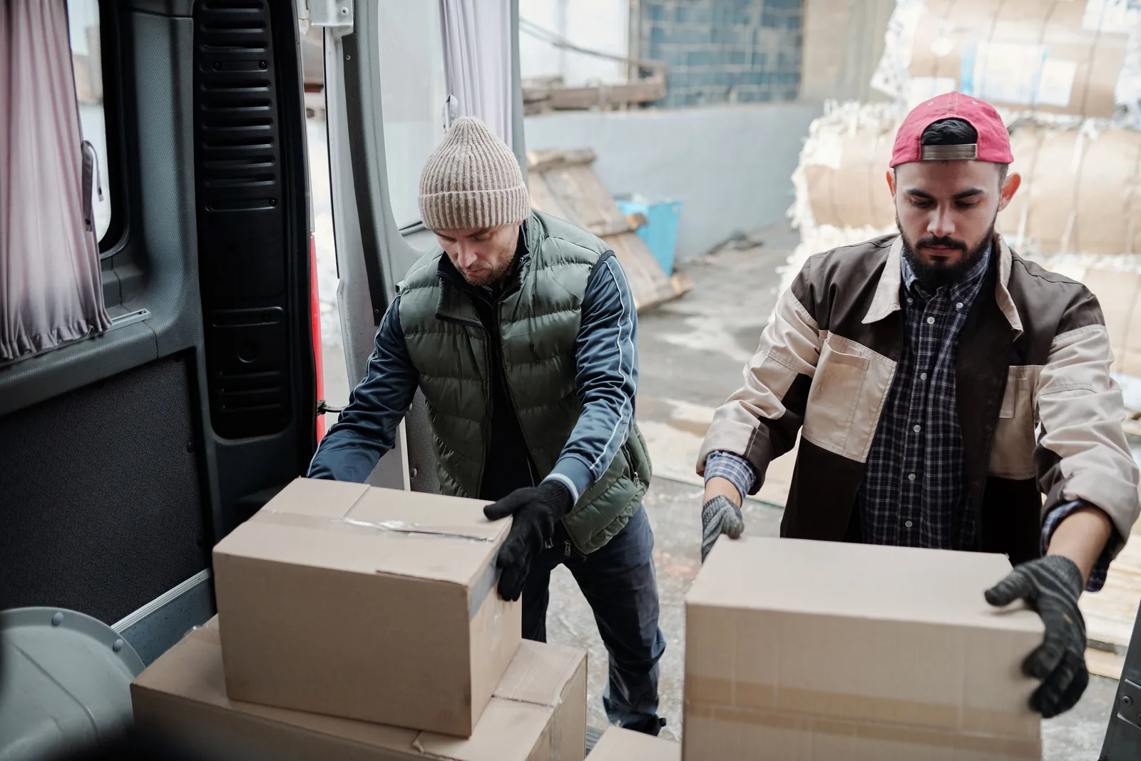 Logistics workers moving cardboard cartons
