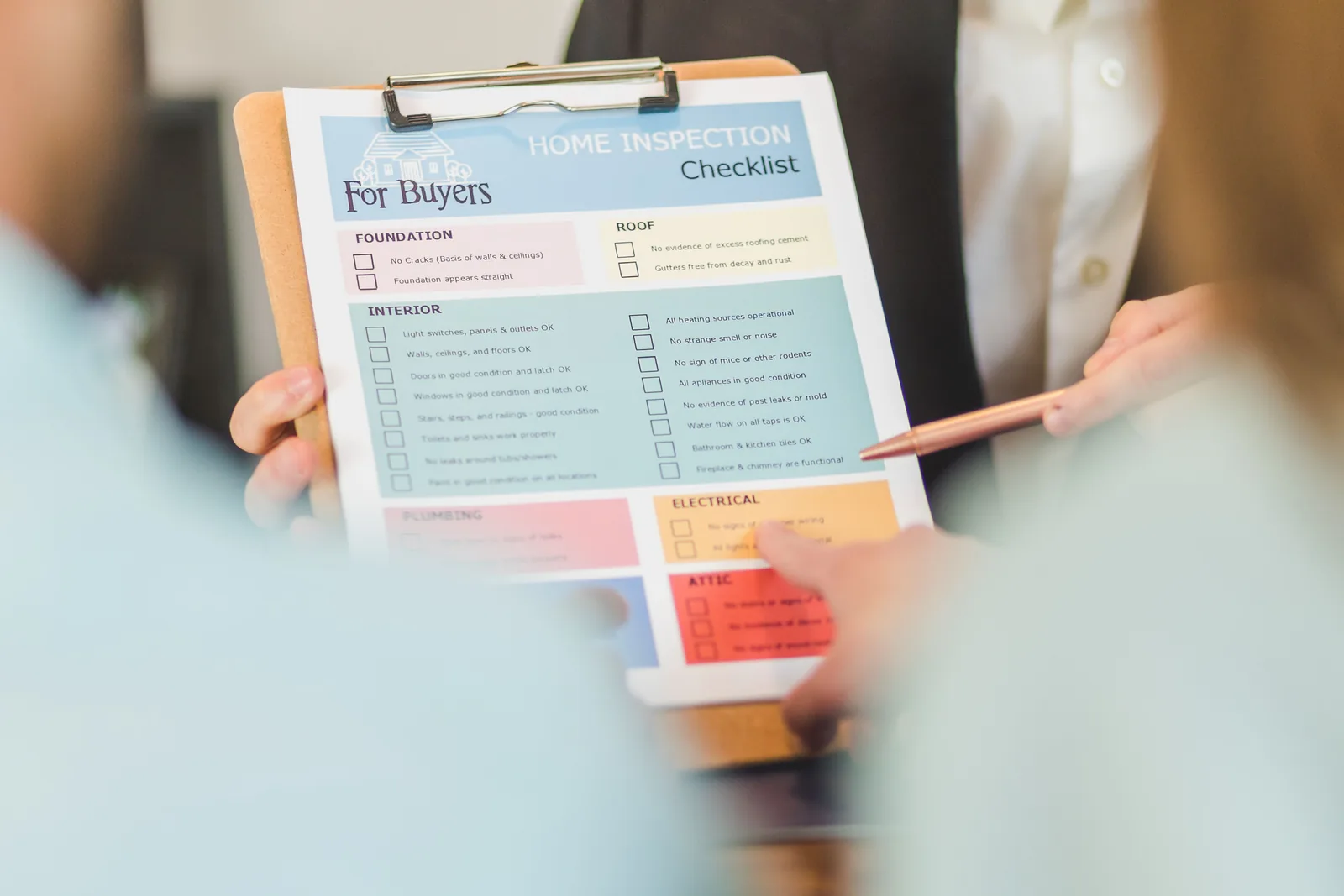 Hands reviewing a generic inspection checklist