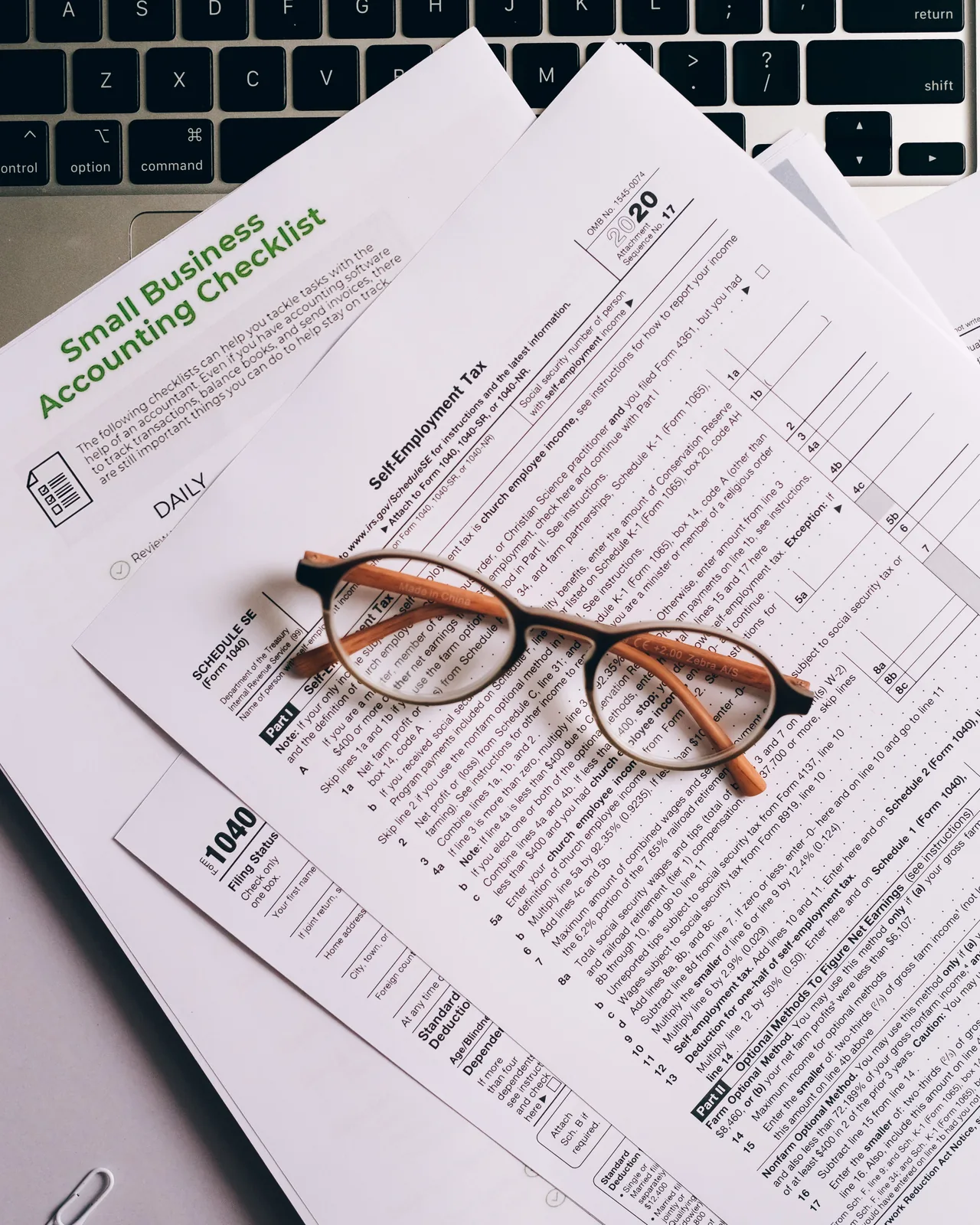 Printed audit records reviewed with a magnifying glass
