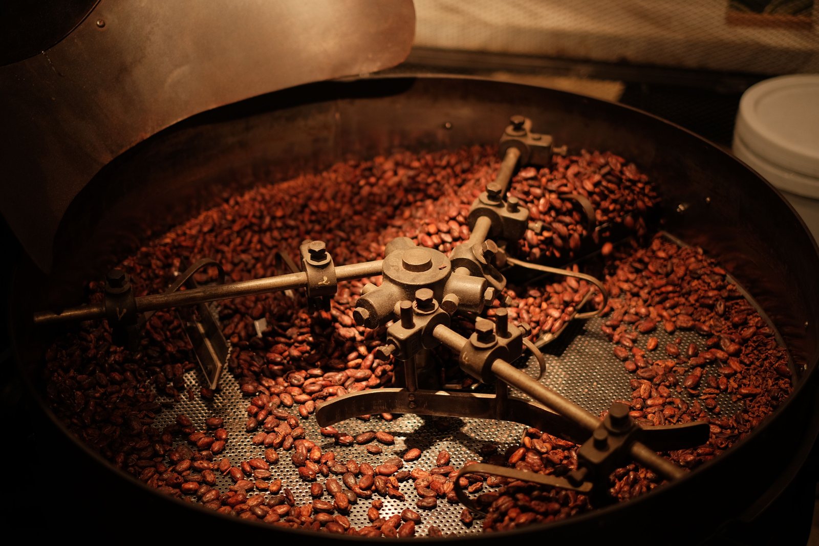 Coffee beans roasting inside industrial equipment
